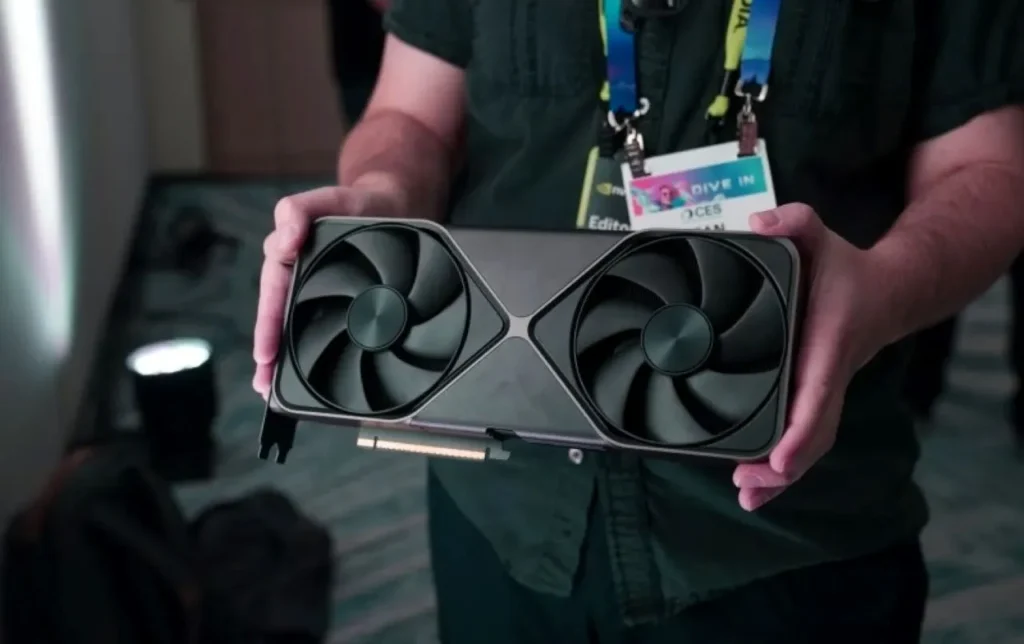 a man holding a video card 